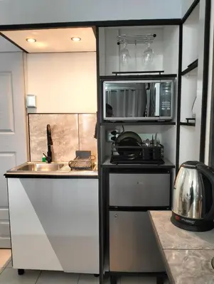 a small kitchen with a sink and a microwave at 20 on Middle in Polokwane