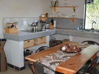 a kitchen with a table with a plate of food on it at Empatia Lodge in Hoedspruit