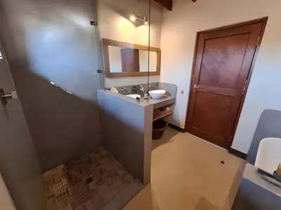 a bathroom with a sink and a mirror at Empatia Lodge in Hoedspruit