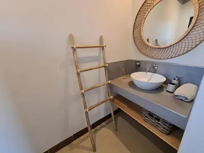 a bathroom with a sink and a mirror at Empatia Lodge in Hoedspruit