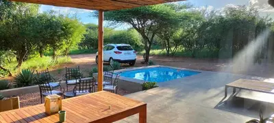 a white van parked next to a swimming pool at Empatia Lodge in Hoedspruit