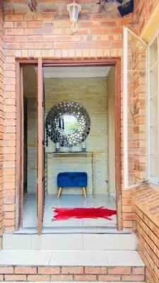 a blue bench sitting in the doorway of a building at Yvee Guesthouse in Hazyview