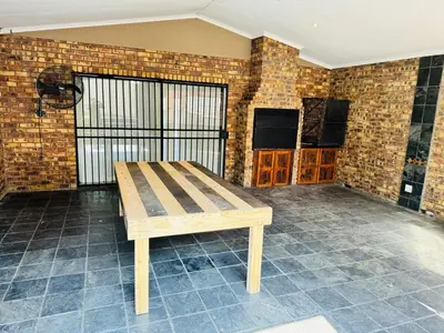 a wooden bench in a room with a brick wall at Home 11 Strydom in Nelspruit