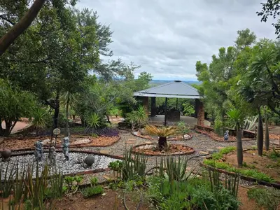 a garden with a fountain and a gazebo at Rocky Mountain Holiday Home in Hartbeespoort