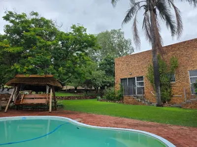 a house with a swimming pool and a gazebo at Rocky Mountain Holiday Home in Hartbeespoort