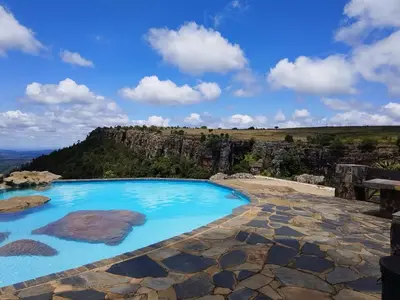 a swimming pool with a view of a mountain at Panorama home 19 in Graskop