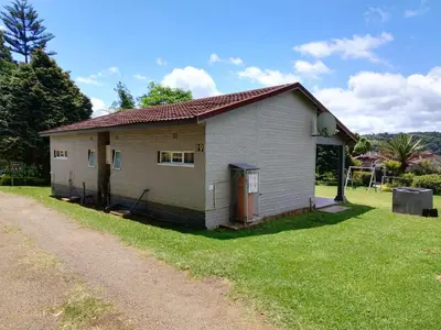 a small house on the side of a dirt road at Panorama home 19 in Graskop