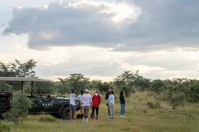 a group of people standing in front of a truck at Tshwene Lodge in Welgevonden Game Reserve