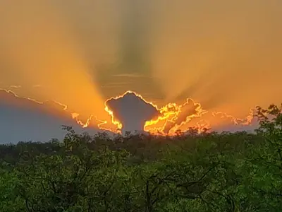 an image of a sunset with clouds in the sky at Rafikis Safari at Kruger in Marloth Park
