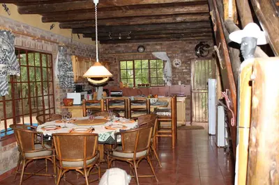a dining room with a table and chairs at Rafikis Safari at Kruger in Marloth Park
