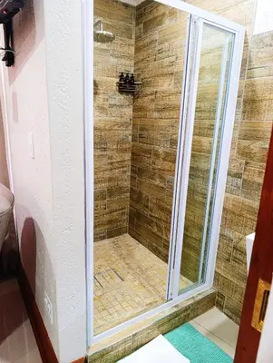 a shower with a glass door in a bathroom at Elephant villa 5 bedroom in Nelspruit