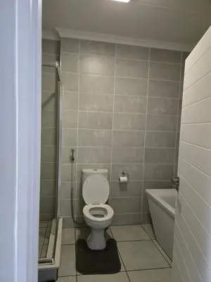 a bathroom with a toilet and a bath tub at Views at The Blyde in Pretoria