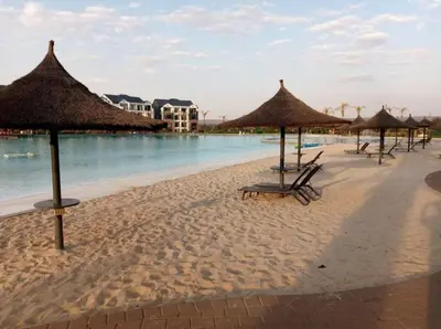 a beach with some chairs and umbrellas and the water at Views at The Blyde in Pretoria