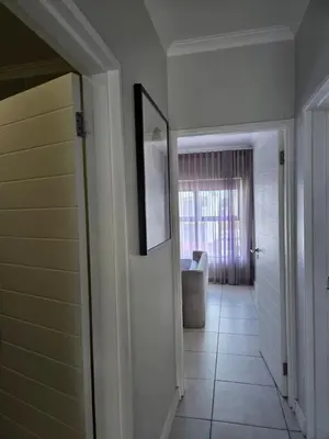 a hallway with a door and a chair in a room at Views at The Blyde in Pretoria