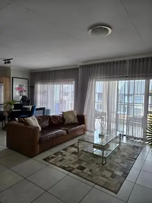 a living room with a couch and a glass table at Views at The Blyde in Pretoria