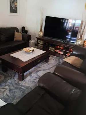 a living room with a coffee table and a flat screen tv at Simunye Retreat in White River
