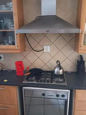 a stove in a kitchen with a tea pot on it at Simunye Retreat in White River