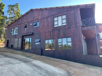 a red barn with windows on the side of it at Shyalongubo dam cabin in Barberton