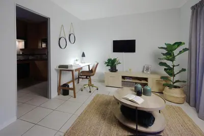a living room with a table and a desk at Ryneveld Rest in Centurion