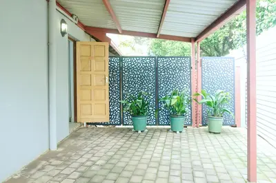 a porch with potted plants in front of a gate at Ryneveld Rest in Centurion