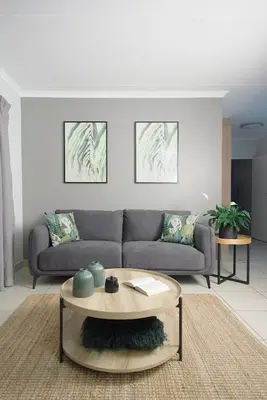a living room with a couch and a table at Ryneveld Rest in Centurion