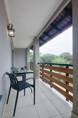 a table and chair on a balcony with a view at Ryneveld Rest in Centurion