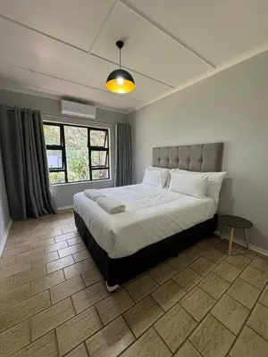 a bedroom with a large bed in a room at Nartjie - Apartment #3 in Nelspruit