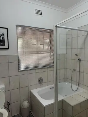 a bathroom with a shower and a bath tub at Nartjie - Apartment #3 in Nelspruit