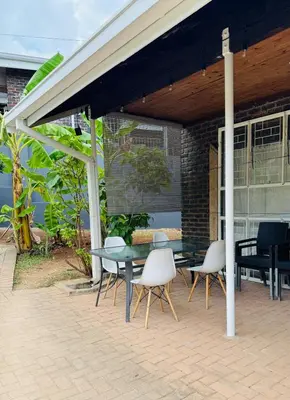 a patio with a table and chairs under a pavilion at Nartjie - Apartment #3 in Nelspruit