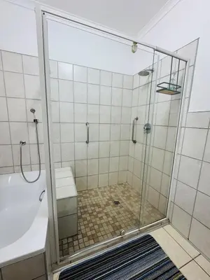 a bathroom with a shower with a toilet and a sink at Nartjie - Apartment #3 in Nelspruit