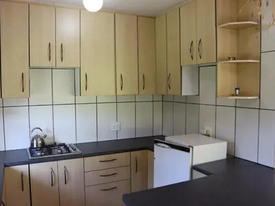 a kitchen with wooden cabinets and a white refrigerator at Guesthouse in the Waterberg in Ouklip