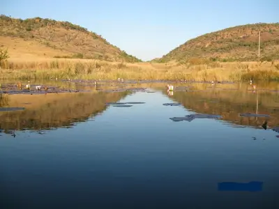 a large body of water with mountains in the background at Guesthouse in the Waterberg in Ouklip
