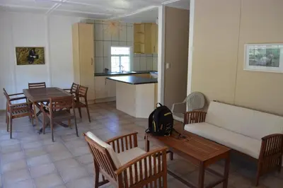 a living room with a couch and a table and chairs at Guesthouse in the Waterberg in Ouklip