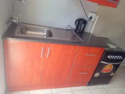 a kitchen with a sink and a stove at Simekhona Guest House in Aangewysd