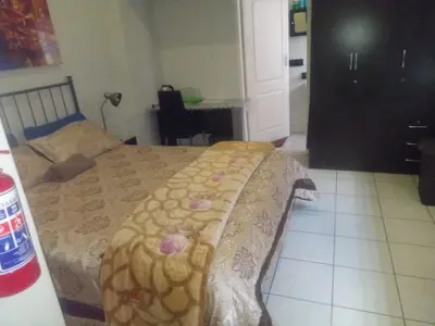 a bedroom with a bed with a blanket on it at Simekhona Guest House in Aangewysd