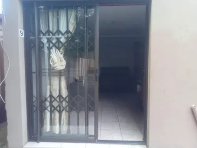 a door to a room with a window with curtains at Simekhona Guest House in Aangewysd