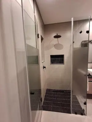 a shower with a glass door in a bathroom at King size bed-NO loadshedding-Free Wi-Fi in Pretoria