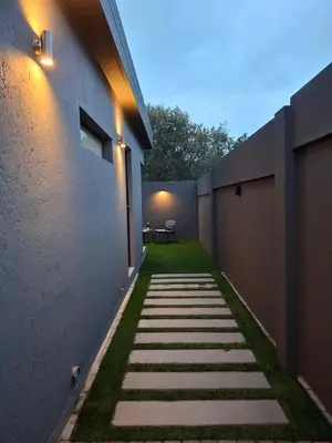 a walkway leading to the side of a building at King size bed-NO loadshedding-Free Wi-Fi in Pretoria