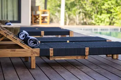 a row of pillows sitting on top of a deck at Villa Visvanger - Villa with river deck nearby Kruger in Hoedspruit