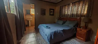 a small bedroom with a bed and a bathroom at Corea Game Ranch in Alldays