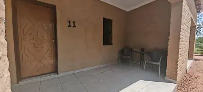 a room with a door and a table and chairs at Corea Game Ranch in Alldays