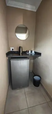a small bathroom with a sink and a mirror at Corea Game Ranch in Alldays