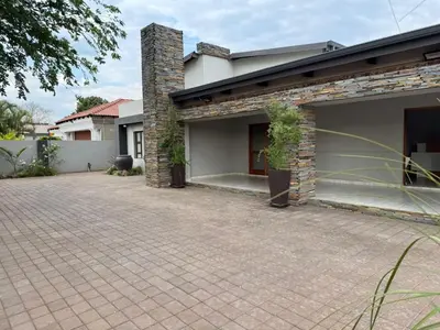 a house with a brick driveway in front of it at Kioma Guest House in Mokopane