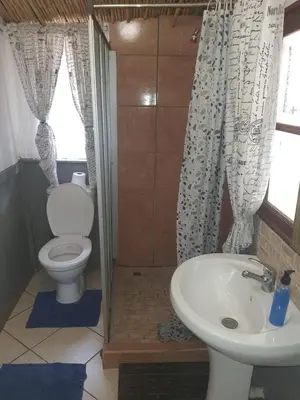 a bathroom with a toilet and a sink at Chalet 3 at Cynthias Country in Hartbeespoort