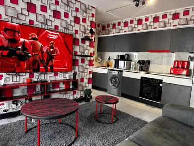 a living room with a tv in a kitchen at Ruby Nest Modern Smart Living in Midrand