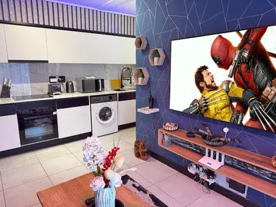 a kitchen with a large screen tv in a kitchen at Xiluva Flower Smart Apartment in Midrand