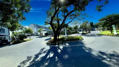 a tree sitting in the middle of a street at Xiluva Flower Smart Apartment in Midrand