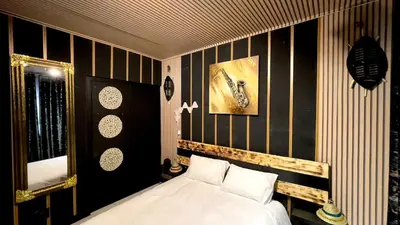 a bedroom with a bed with black and white stripes at Xiluva Flower Smart Apartment in Midrand