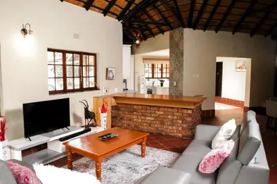 a living room with a couch and a fireplace at Ukhanya resort in Midrand