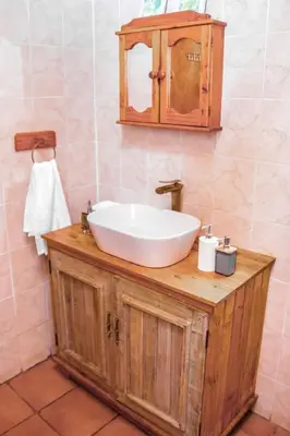 a bathroom with a white sink and a mirror at Ukhanya resort in Midrand